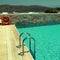 Patio and resort pool overlooking the Mediterranean sea