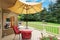 Patio table with yellow umbrella on walkout deck