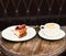 Patisserie concept. Cheesecake with berries and coffee on wooden table