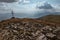 Patriarchal cross on the mountain summit with spectacular sun rays through the clouds. Low Tatras Nizke Tatry Crest Trail