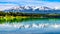 Patricia Lake with reflections of the snow capped peaks of the Rocky Mountains in Jasper National Park