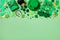 Patrick Day festive green background decorated with shamrocks, leprechaun hat, golden coins and gifts