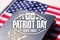 Patriot day seal over an american passport and flag
