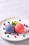 Patriotic colors ice cream scoops on white plate, top view