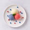 Patriotic colors ice cream scoops on white plate, top view