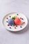 Patriotic colors ice cream scoops on white plate, top view