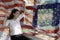 Patriotic composite of happy young half Thai-American woman in h