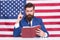 Patriotic concept. American lawyer teacher or tv host hold book american flag background. Love homeland. Man with beard