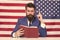 Patriotic concept. American lawyer teacher or tv host hold book american flag background. Love homeland. Man with beard