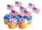 Patriotic cupcakes decorated with American Flags and blue, white cream with red stars sprinkles on the top, isolated