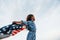 Patriotic female kid with American Flag in hands. Against cloudy sky