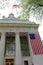 Patriotic flags hanging from the large stone front of Adirondack Trust Bank,Saratoga,New York,2015