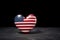 Patriotic heart shape with USA flag on black backdrop. Generate ai