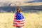 Patriotic holiday. Happy kid, cute little child girl with American flag. USA celebrate 4th of July.