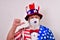 Patriotic man pointing to his face mask