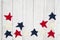 Patriotic red, white and blue stars on weathered whitewash textured wood background
