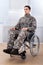 Patriotic soldier sitting on wheel chair