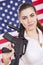 Patriotic woman with gun over american flag