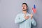 Patriotic young man holding US flag