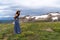 Patriotic young woman laughs wearing an American Flag dress on the Beartooth Highway in Wyoming