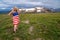 Patriotic young woman poses in a wildflower field along the Beartooth Highway in Wyoming