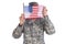 Patriotism Concept. A soldier in camouflage fatigues holding an Americam Flag in front of his face