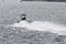 Patrol boat flying over choppy water in New Bedford outer harbor