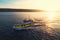 Patrol boat sailing at sunset in shining golden sea water