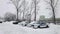 Patrol police cars parked in the parking area during snow storm.
