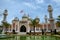 Pattani central mosque courtyard with pond minarets and Thai flag Thailand