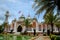 Pattani central mosque courtyard with pond minarets and Thai flag Thailand