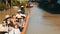 PATTAYA, THAILAND - December 18, 2017: Different boats with tourists riding them on the river in a floating market