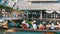 Pattaya, Thailand - December 18, 2017: Different boats with tourists riding them on the river in a floating market