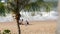 PATTAYA, THAILAND - DECEMBER 25, 2017: Little boy in a swimming suit makes something of sand with his mother. Beach with