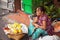 Pattaya, Thailand - March 28, 2016: Thai street vendor selling fruits from baskets. Food seller