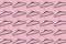 Pattern of black hangers isolated on background of pastel pink color.