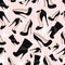 Pattern of black shoes with glitter on a pink background