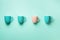 Pattern from blue and pink cups over turquoise background. Birthday party celebration, baby shower concept. Punchy