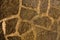 Pattern brown color of old stone wall uneven cracked real stone wall surface with cement