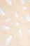 Pattern of brush strokes and drops of cosmetic oil and serum top view on beige background