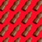 Pattern chocolate Santa Claus on a red background. Sweet Christmas candy. Sweet food for the holiday. Treat