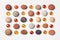 Pattern of colored pebbles and orange glass beads on white wooden background. Flat lay, top view