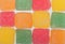 Pattern of colorful cubes jelly candies, row of sweet food texture background.