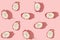 Pattern created from fresh exotic dragon fruits halfs on pastel pink background. Top view