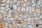 Pattern of decorative brown stone wall. Old castle wall background. Random size rock structure. Neatly stacked rough cut stone