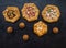 Pattern of different handmade pies on a black kitchen table.