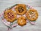 Pattern of different handmade pies on a white wooden table.