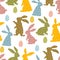 A pattern of Easter bunnies made of polka dot fabric and colored eggs. Rabbit toys for children. Rabbit or hare, a