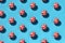 Pattern of Easter eggs in red with white spots on a blue background. Creative concept