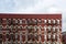 Pattern of fire escapes on side of older ornate brick building